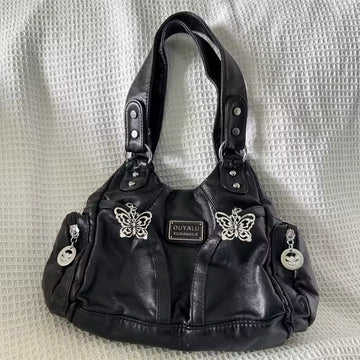 Grunge purse with adjustable strap on model