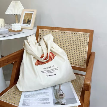 Front view of the Croissant Canvas Tote Bag showcasing the bread illustration.