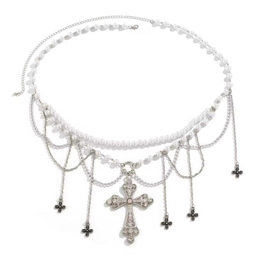 Gothic pearl belly chain with cross charm and tassels, worn over black mini skirt