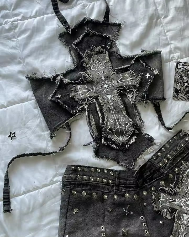 Black denim mini skirt and cropped top with embroidered cross design and silver studs