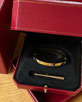 Elegant designer gold bangle featuring four sparkling crystals