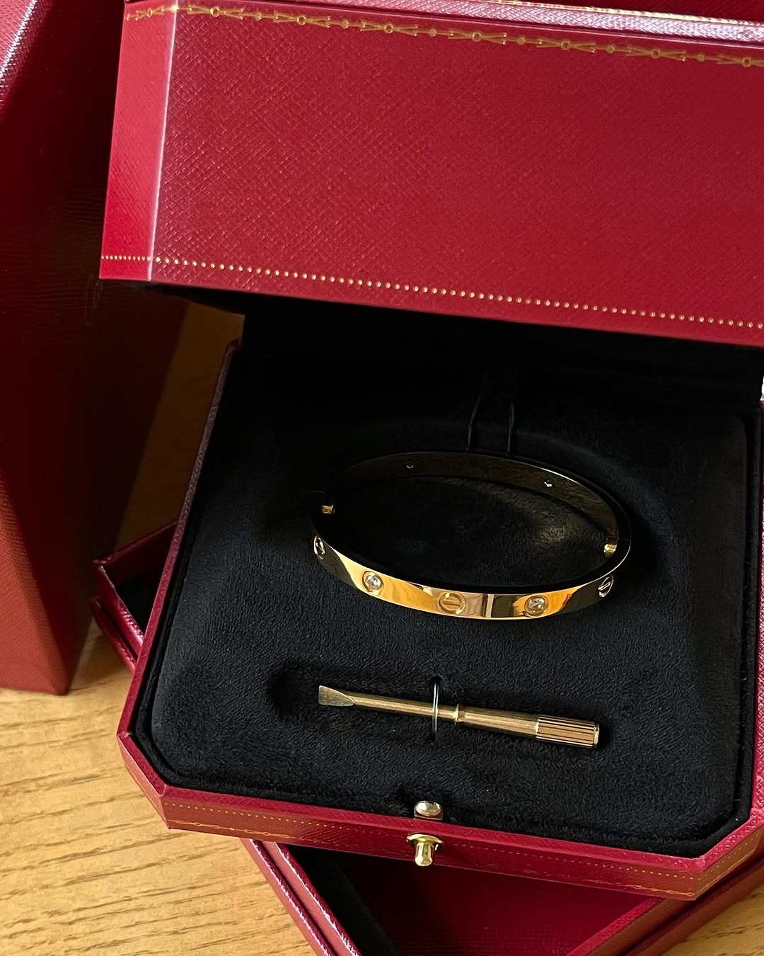 Elegant designer gold bangle featuring four sparkling crystals