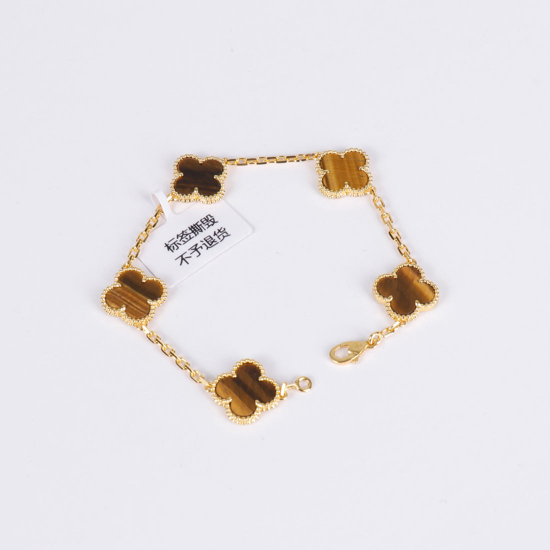 Gemstone charm bracelet with brown clover in gold setting