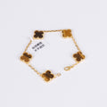 Four-leaf clover bracelet featuring tiger eye charm and gold plating