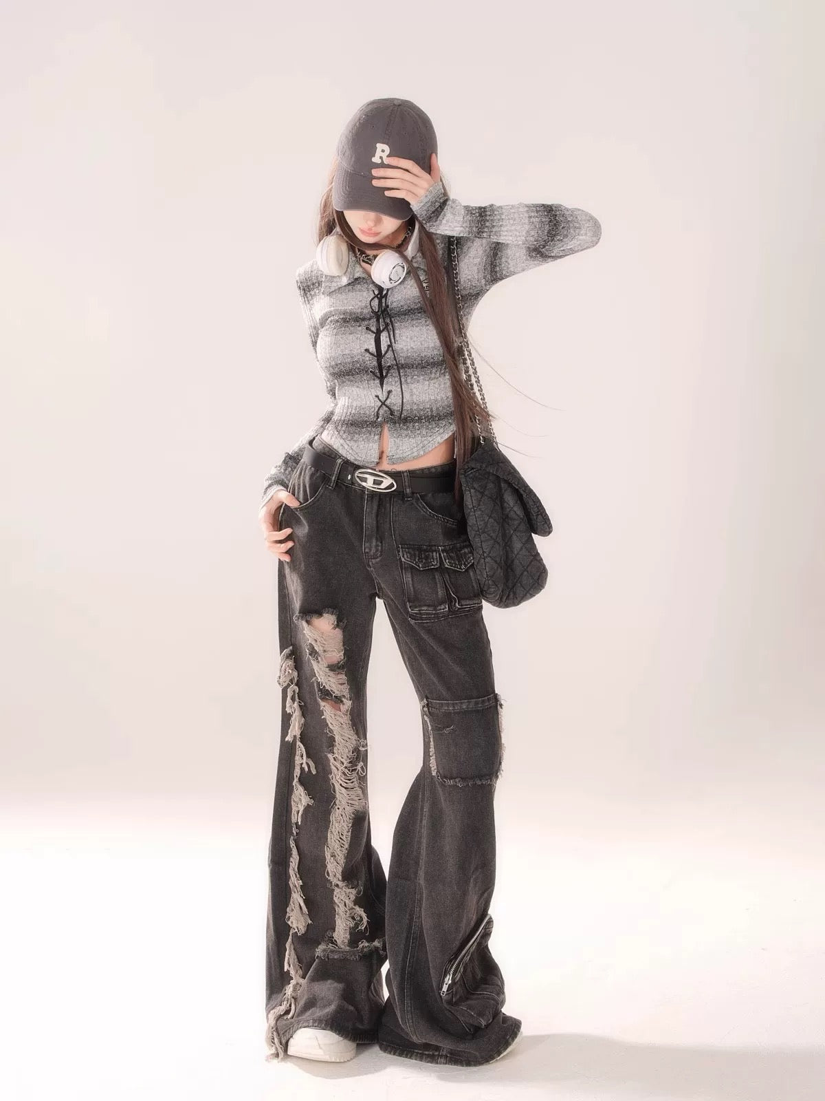 Close-up of the ripped knee area, emphasizing the punk-inspired distressed elements.