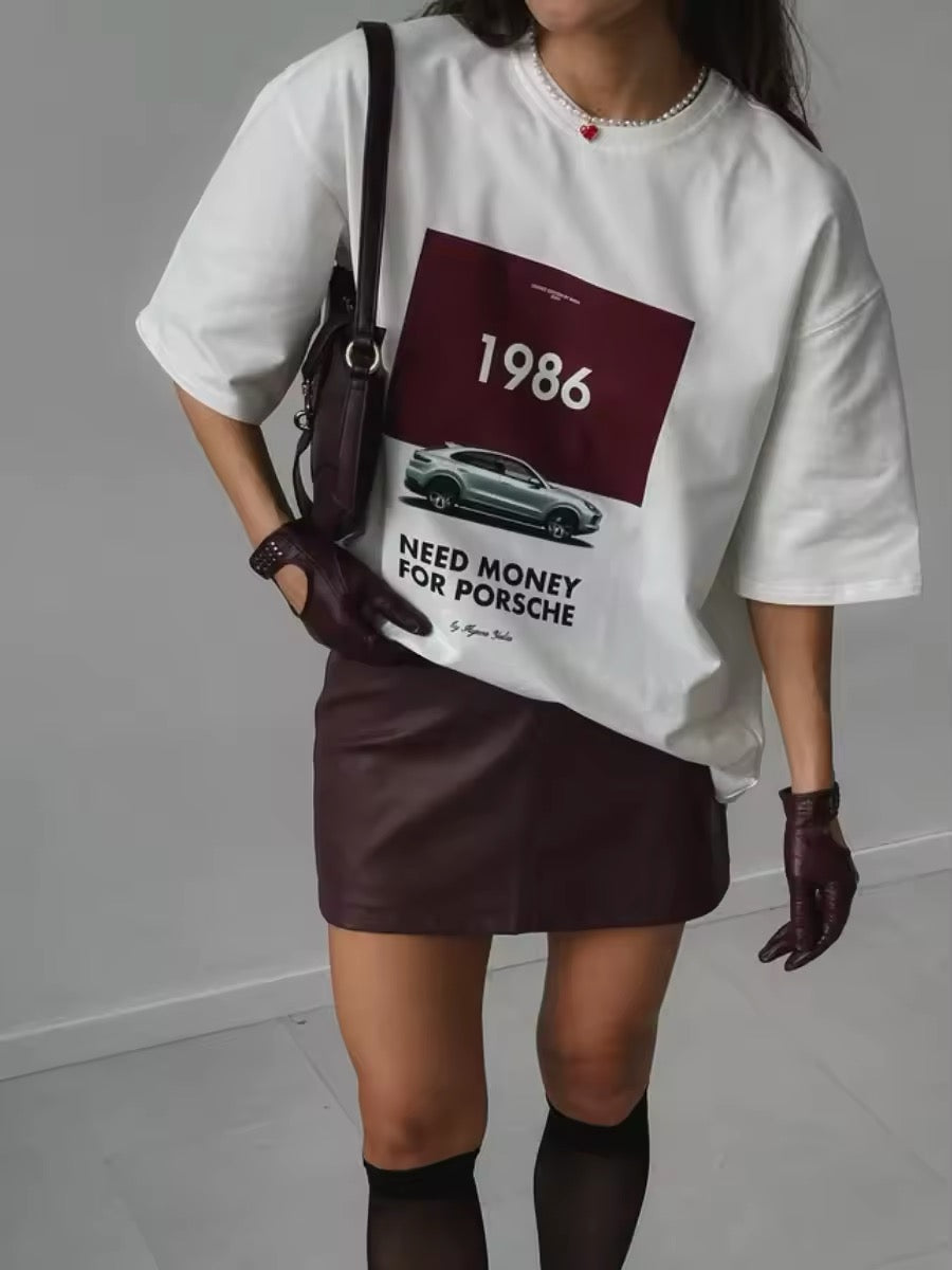 Oversized white Porsche t-shirt with 1986 print on bed