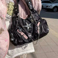 Edgy black leather tote with chunky silver chain straps