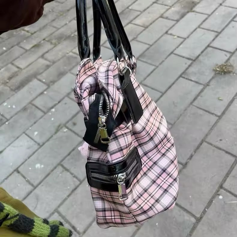 Model walking in an urban setting, the bag complementing her e-girl look.