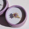 Close-up of earring clasp design and opal gem sparkle.

