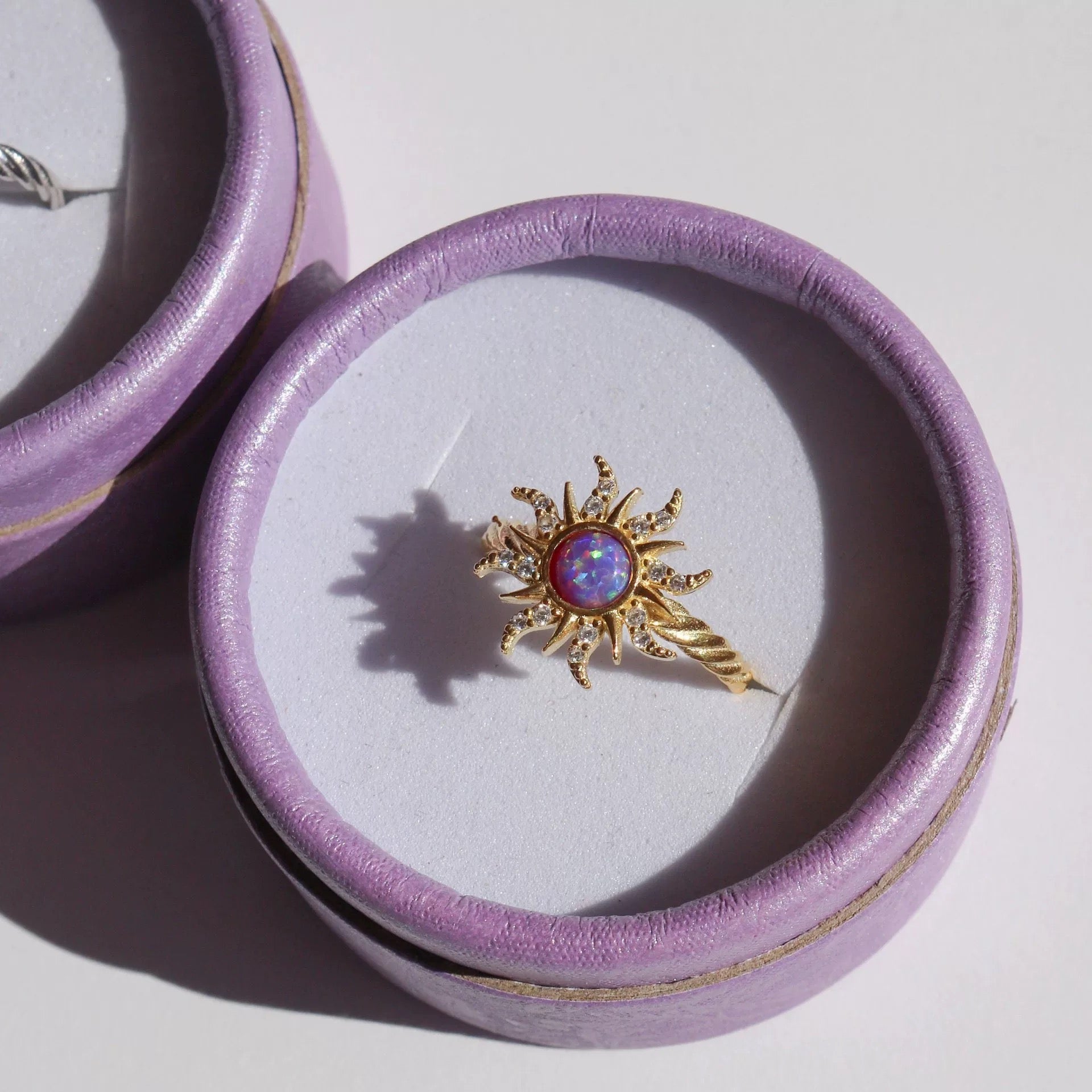 Close-up of earring clasp design and opal gem sparkle.

