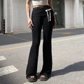 Balletcore-inspired lace patchwork flare pants, Y2K aesthetic low-waisted bootcut trousers with contrast bow details, perfect for Pilates girl outfits