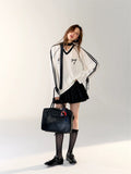 Side profile showing bow ties on sleeve cuffs of the Coquette Sporty Top.