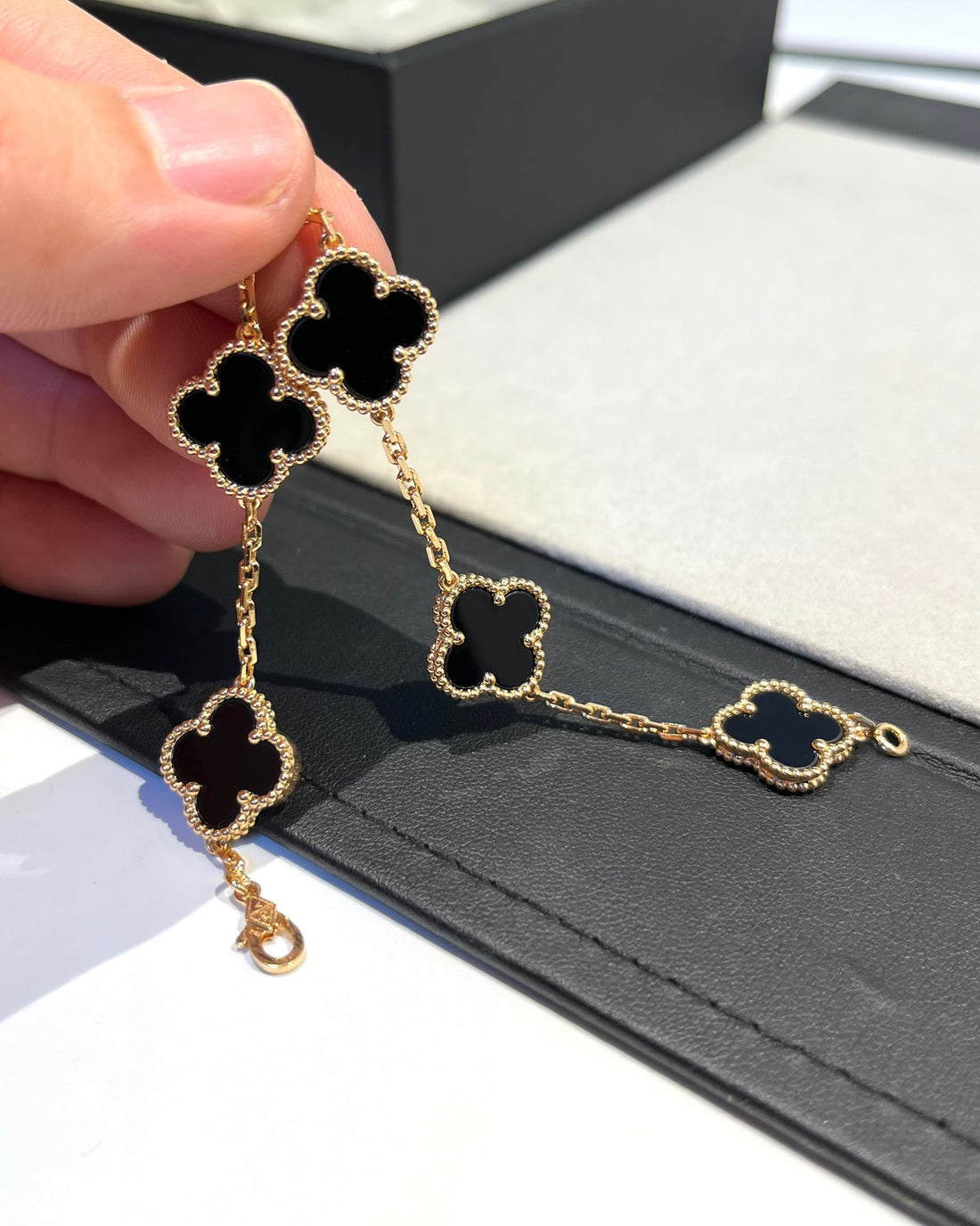 Four-leaf clover bracelet in gold and black enamel
