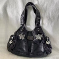 Grunge purse with adjustable strap on model