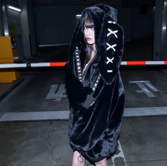 Black fluffy zip-up coat with ear details and bold style