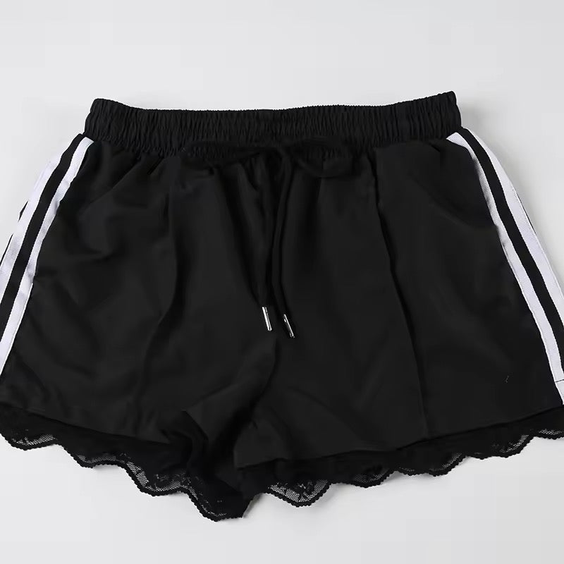 White athletic shorts with black side stripes and lace hem detail