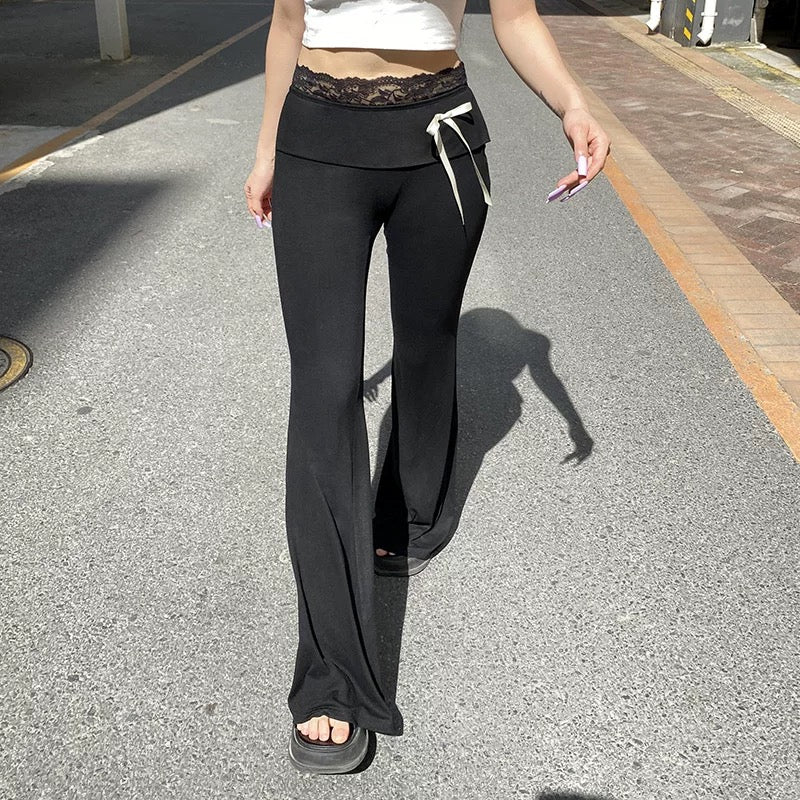 Y2K balletcore lace patchwork flare pants, soft black bootcut trousers with contrast bows and lace trim, ideal for coquette streetwear and soft feminine looks