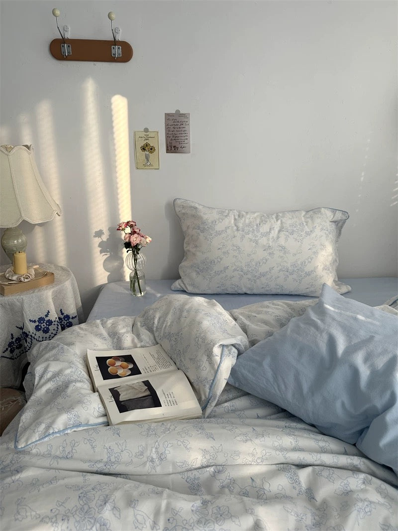 Cozy bedroom with a bed, side table, and window with curtains.