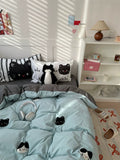 Bedroom with cat-themed bedding and decor