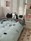 Bedroom with cat-themed bedding and decor