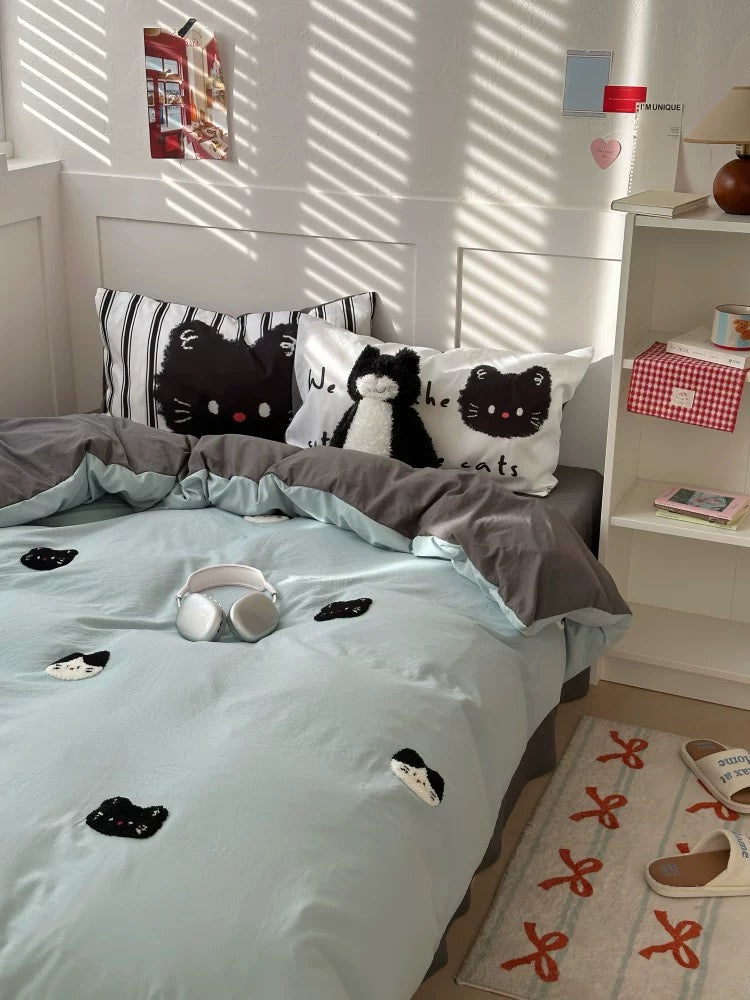 Bedroom with cat-themed bedding and decor