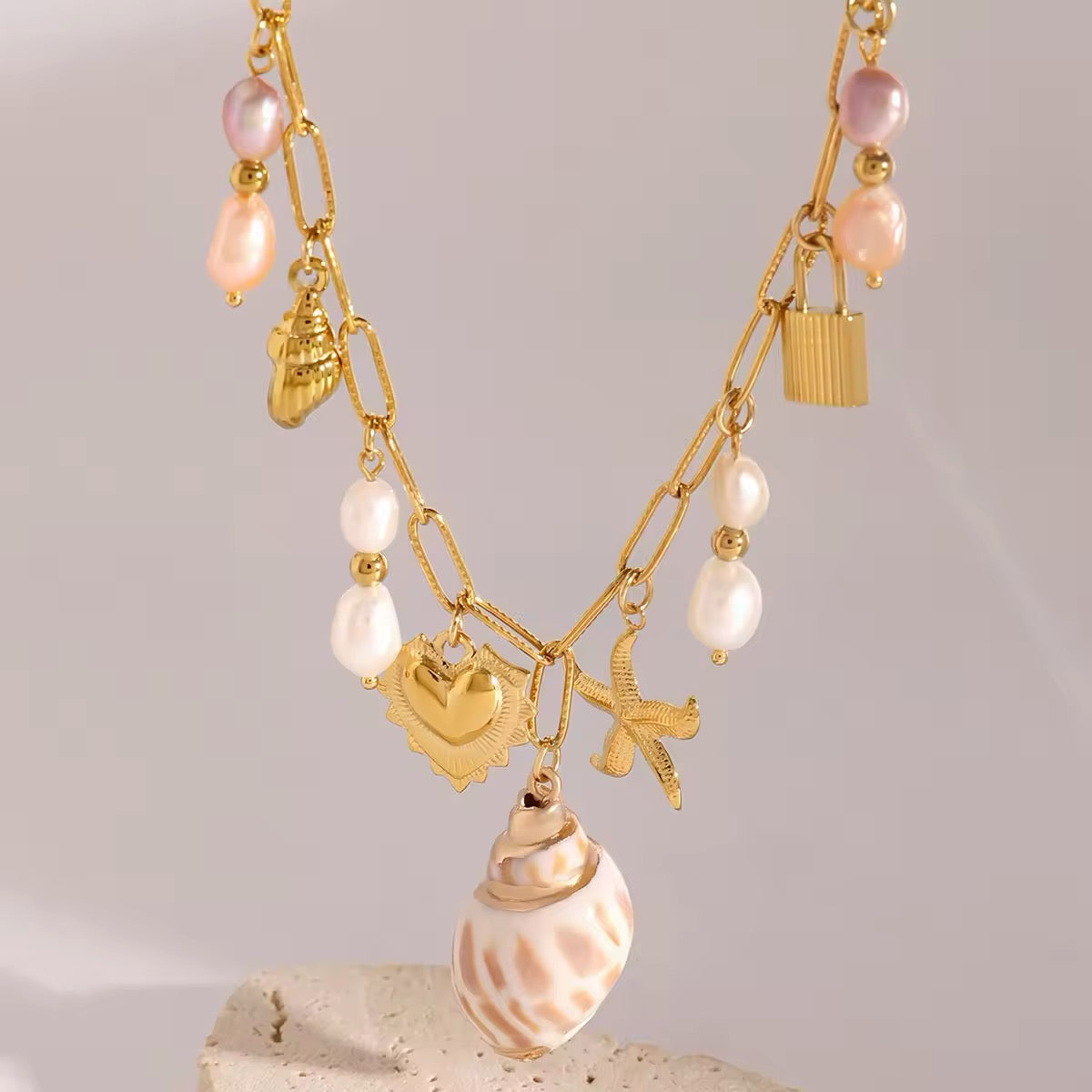 Trendy boho charm necklace with gold starfish and shell pendant