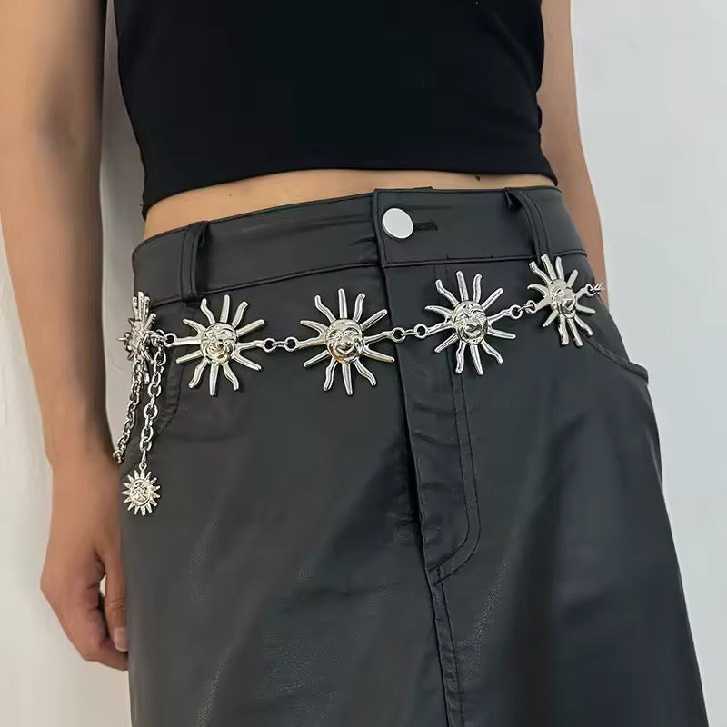 Celestial chain belt styled over black dress with gold moon and star pendants