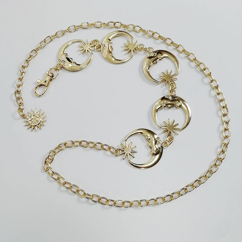 Close-up of celestial moon charm on a gold chain belt for women
