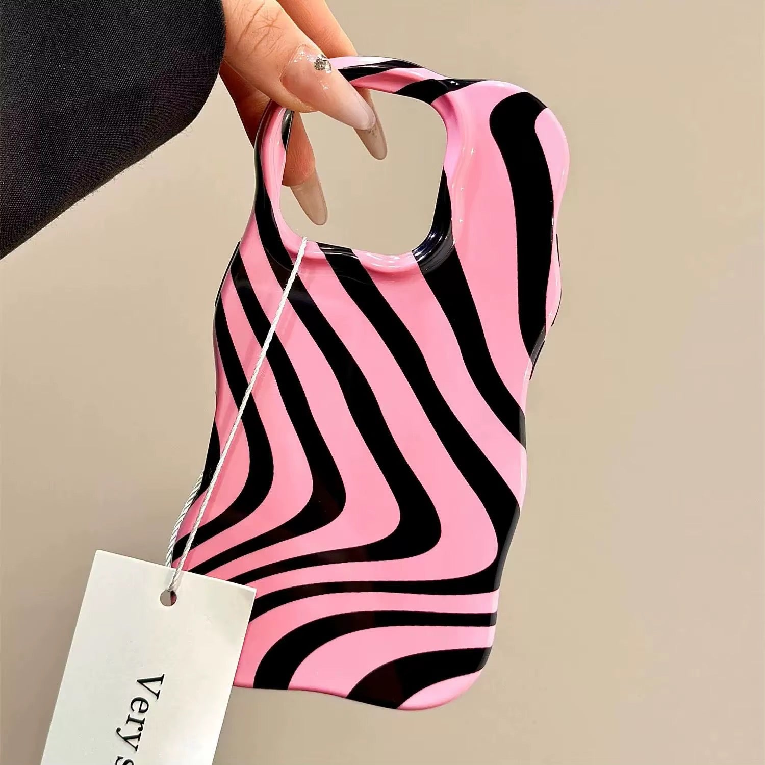 Close-up of the black and pink stripes merging in a wave design on the iPhone case.
