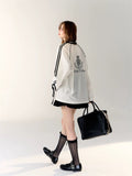 Trendy balletcore streetwear look with oversized jersey top and soft girl makeup.