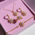 Adjustable gold ring with multicolored stones and sunburst design, fairycore vibe.