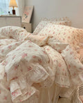 Floral patterned bedding set on a bed in a bedroom setting.