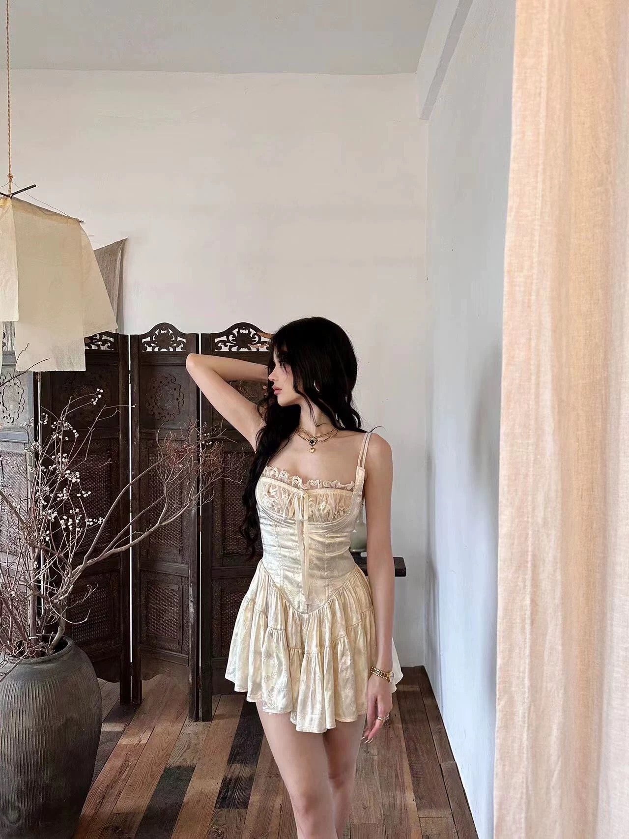 Cottagecore inspired cami romper with corset details and flared hem.