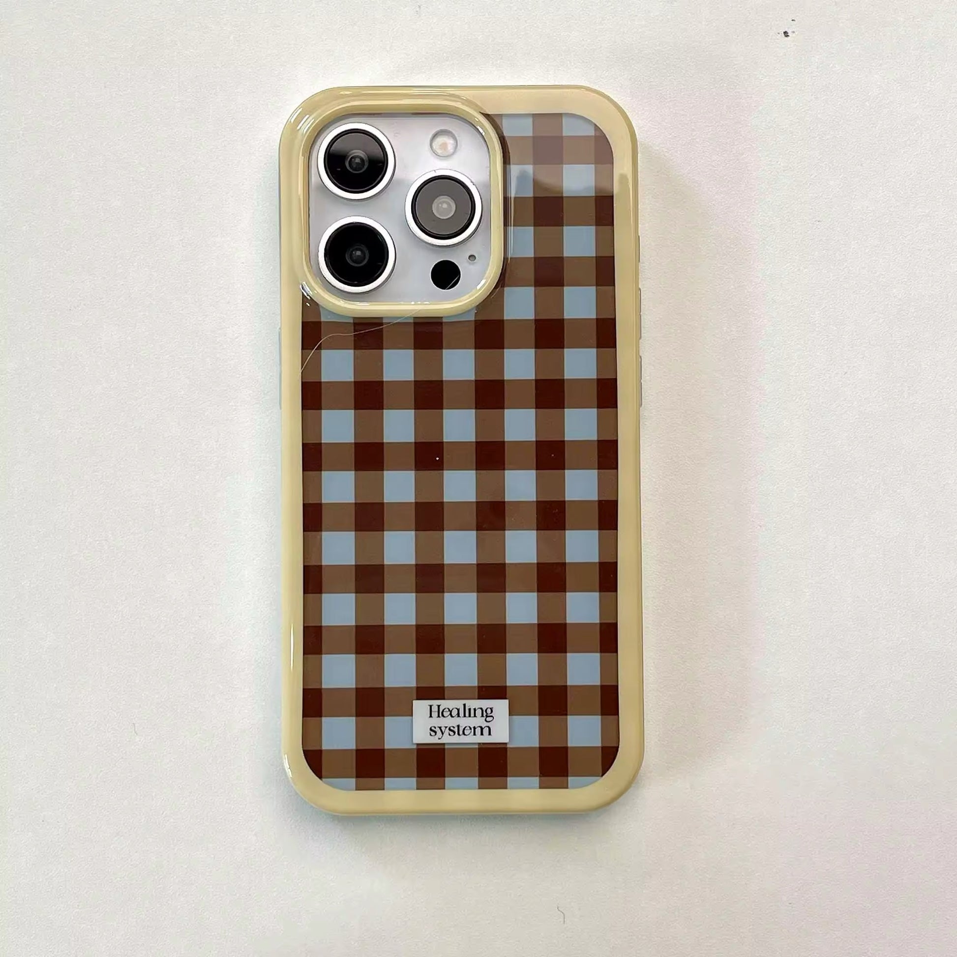 The case shown with a matching brown charging cable and earbuds