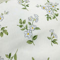 Floral pattern with white flowers and green leaves on a white background