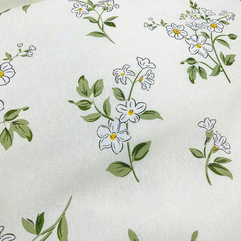 Floral pattern with white flowers and green leaves on a white background