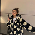 Model wearing pink plush heart coat on the street