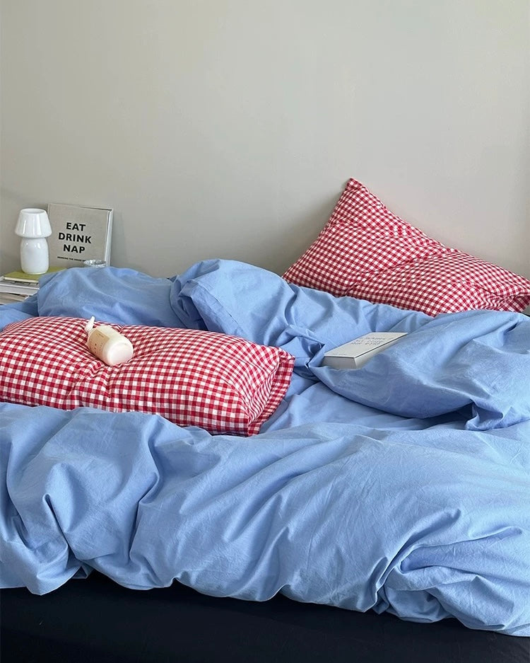 Korean minimalist bedroom featuring blue cotton duvet and plaid pillows