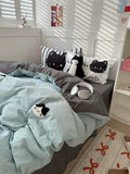 Bedroom with cat-themed bedding and pillows