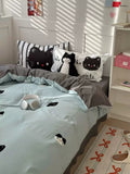 Bedroom with cat-themed bedding and decor