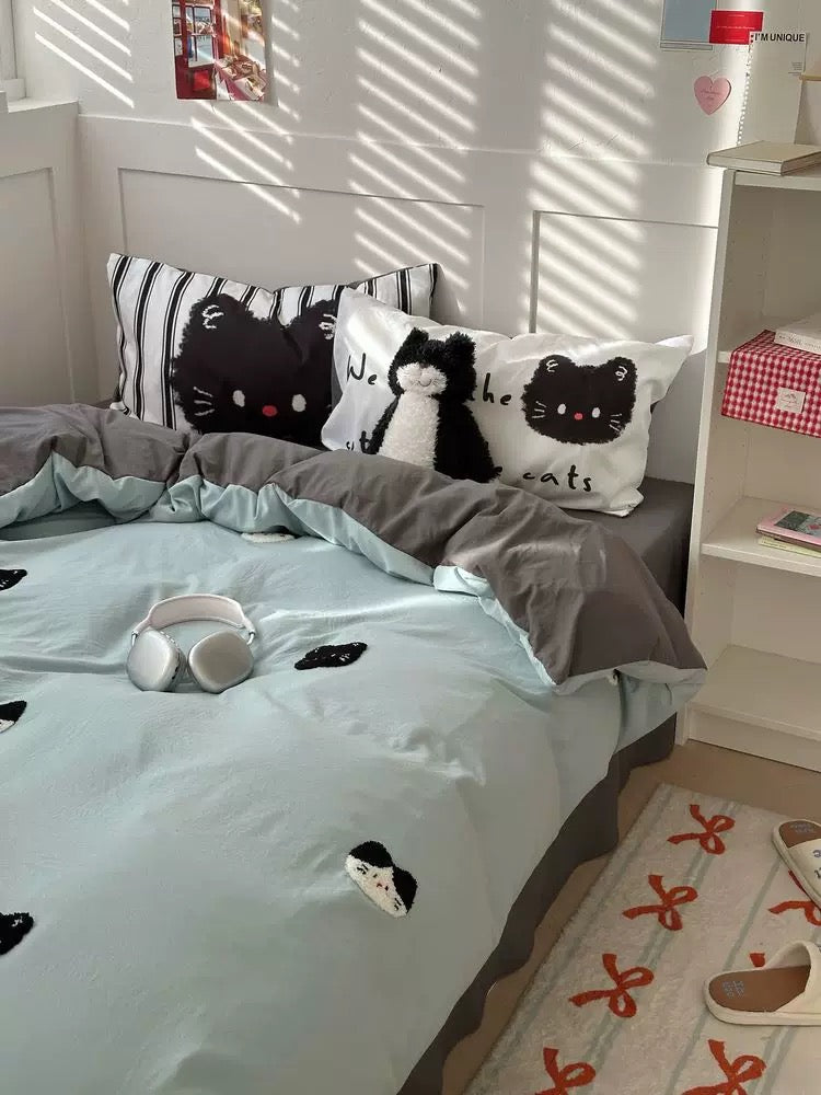 Bedroom with cat-themed bedding and decor