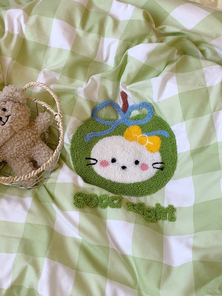 Plush toy with a decorative patch on a green and white checkered fabric
