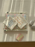 Stack of folded towels with cartoon designs on a textured surface