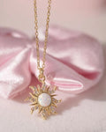 Soft glow of opal gemstone contrasted with golden metal for radiant aesthetic.
