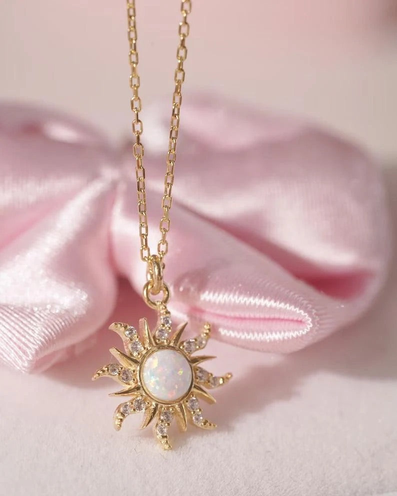 Soft glow of opal gemstone contrasted with golden metal for radiant aesthetic.