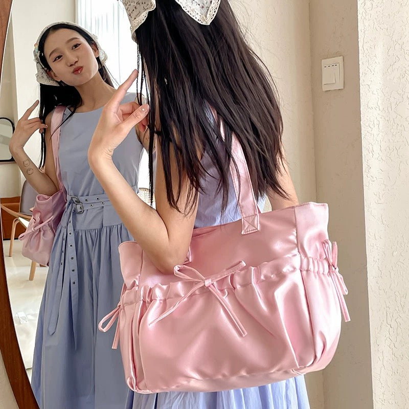 Pink satin handbag styled with coquette outfit