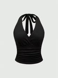 Black halter top with bow detail on a light gray background