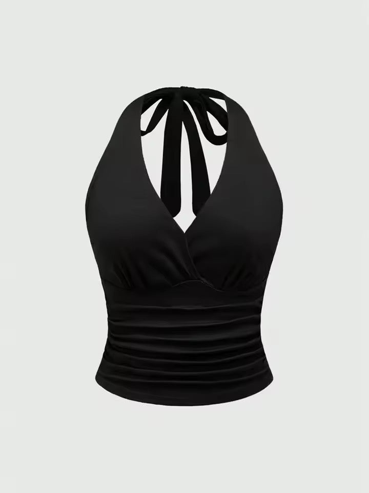 Black halter top with bow detail on a light gray background