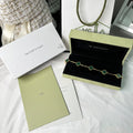 V-Gold bracelet with green clover detail and shiny finish