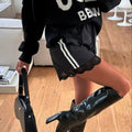 2000s inspired sporty shorts with feminine lace and bold lines